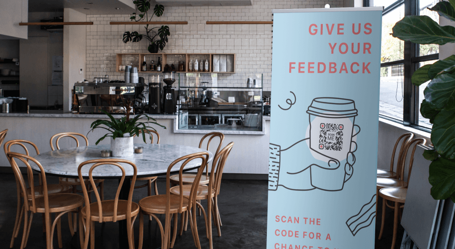 A QR Code advertisement in a coffee shop asking customers to provide feedback.