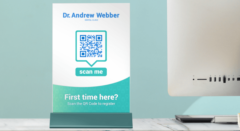 A table tent at a dental clinic featuring a QR Code that allows new patients to register.